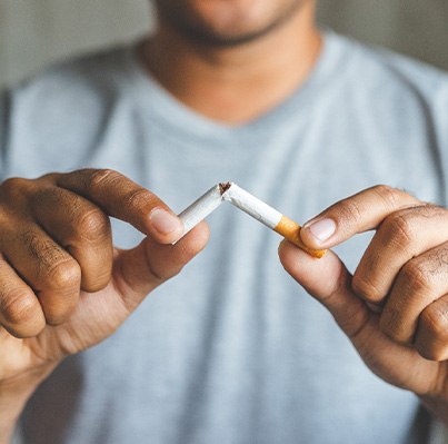 Closeup of patient breaking cigarette