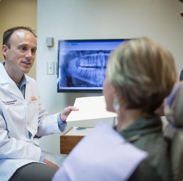 Dentist talking to dental patient