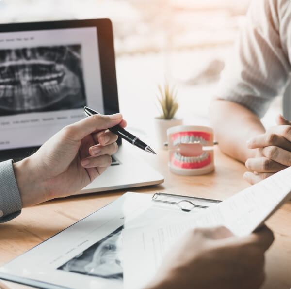 Dentist discussing dental service options with patient