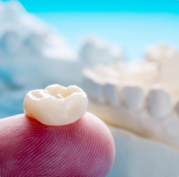 Dental crown on fingertip