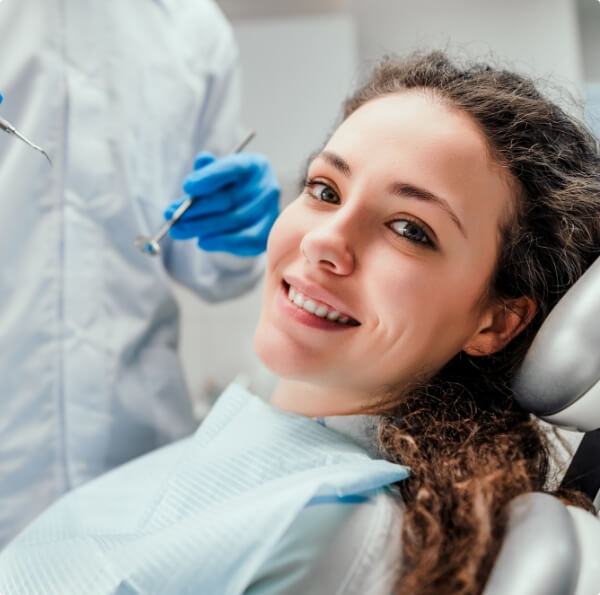 Woman smiling during preventive dentistry checkup and teeth cleaning visit