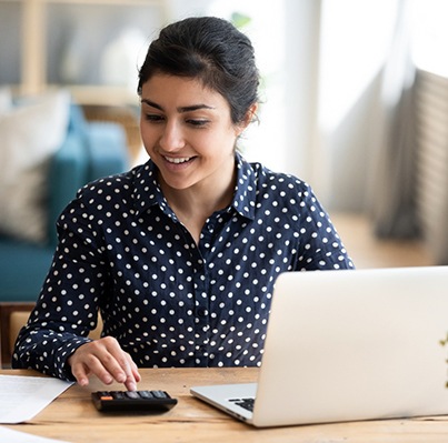 a woman calculating the cost of cosmetic dentistry