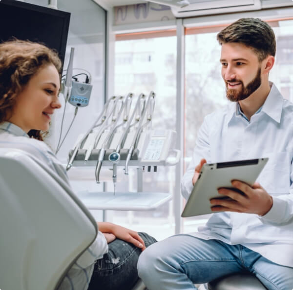 Cosmetic dentist and dental patient discussing payment options