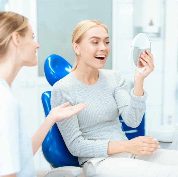 Woman looking at smile in mirror