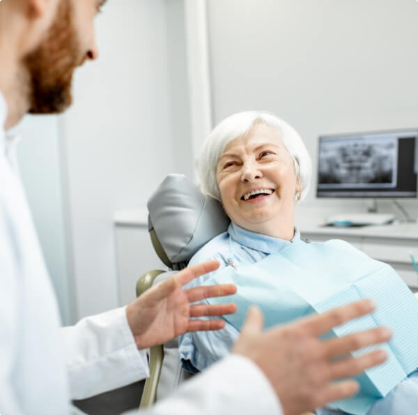 Woman laughing with her dentist in the dental office