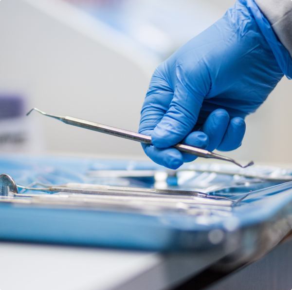 Dentist placing dental treatment tools