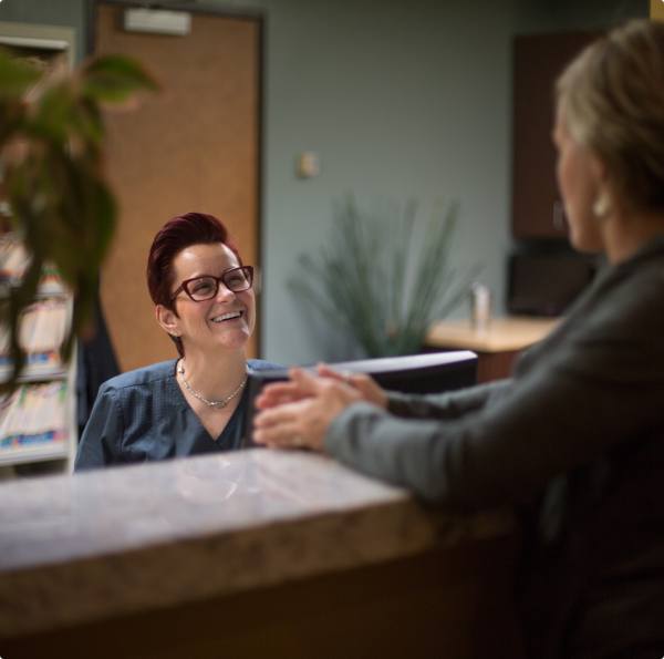 Dentisry team member and patient discussing the cost of dental emergencies