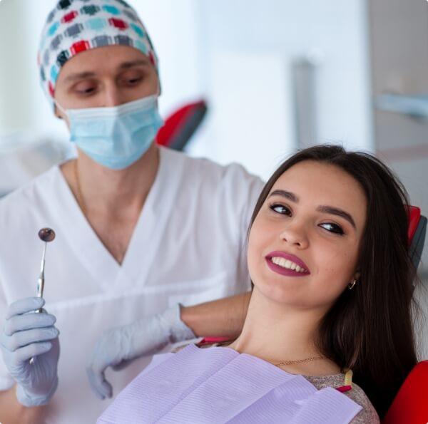 Cosemtic dentist treating dental patient