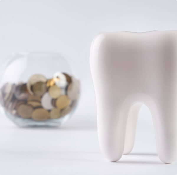 Model tooth and jar of coins