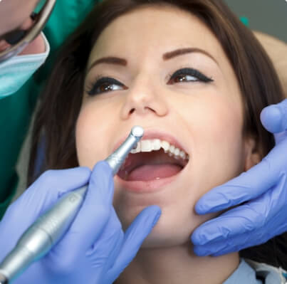 Dentist providing dental patient with periodontal maintenance treatment