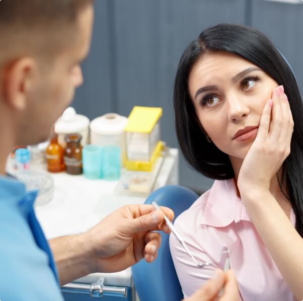 Woman with toothache before root canal treatment