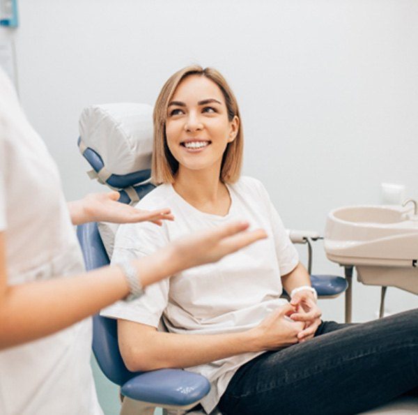 woman talking to dentist about veneers in Oklahoma City  