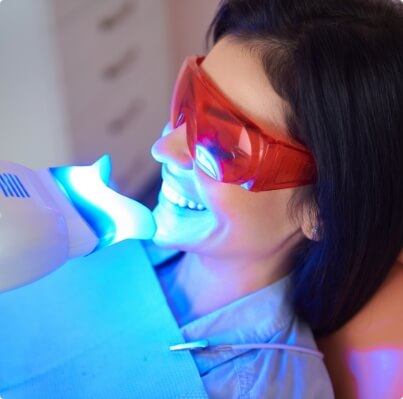 Woman receiving in office teeth whitening