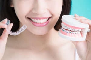 woman comparing braces and invisalign
