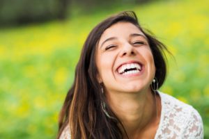 Woman smiling outside feeling positive