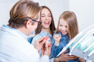 Mother and daughter talking with their dentist in OKC