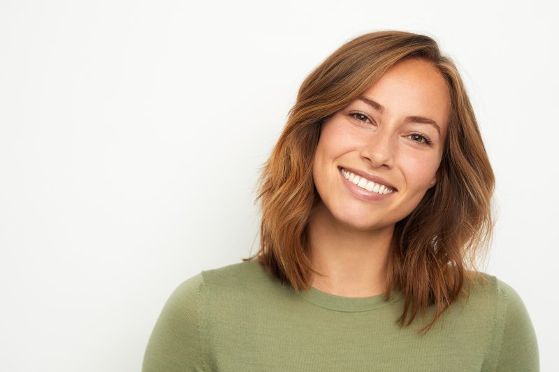 woman smiling after getting crowns and fillings in Oklahoma City