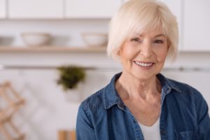 Smiling senior woman enjoying the benefits of implant dentures