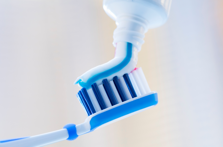 Toothpaste being put on brush