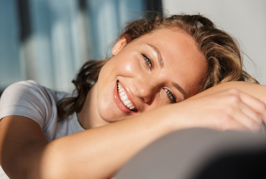 Woman smiling, leaning on chair